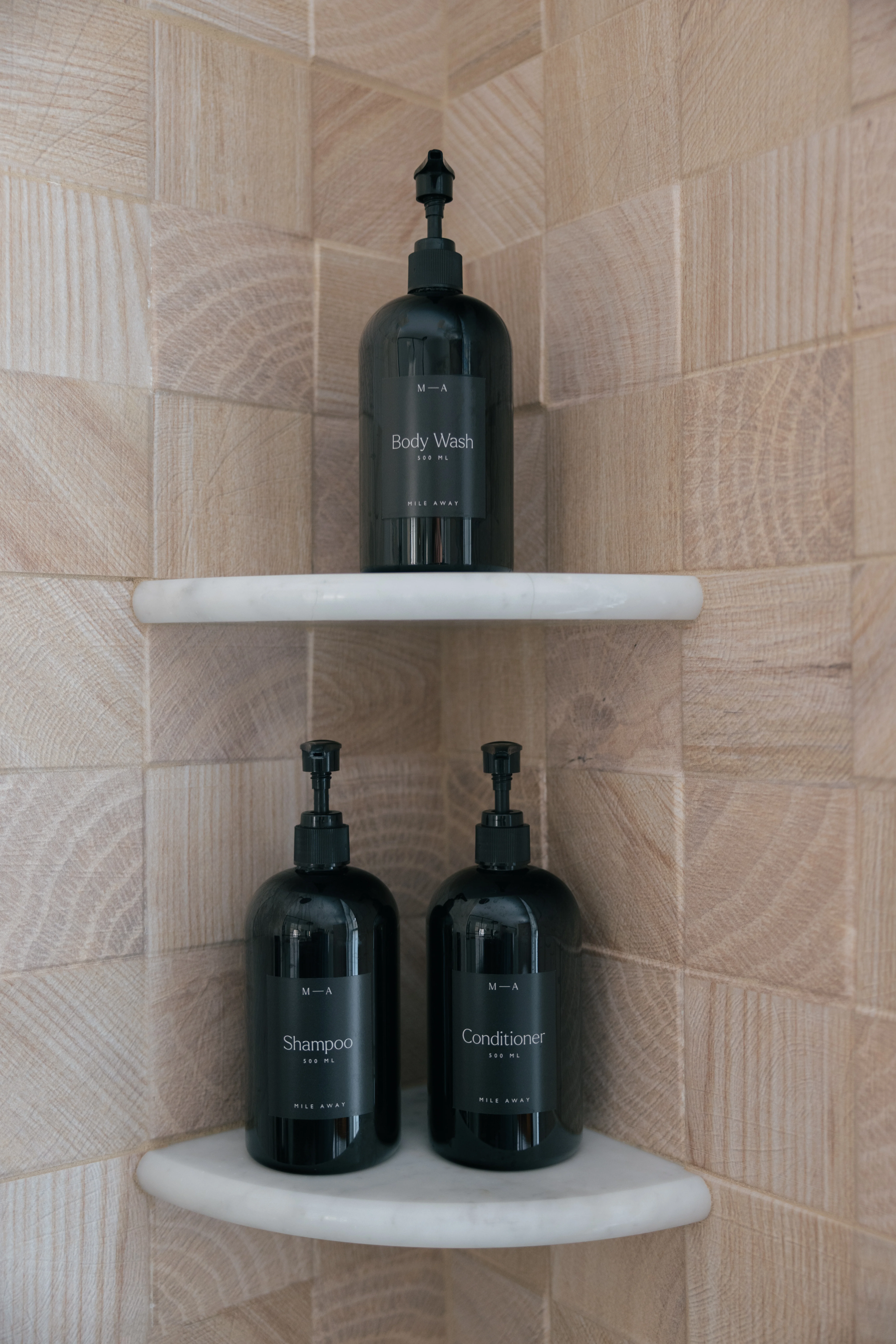 Master bathroom second angle showing the walk-in shower and wood-grain tile wall details